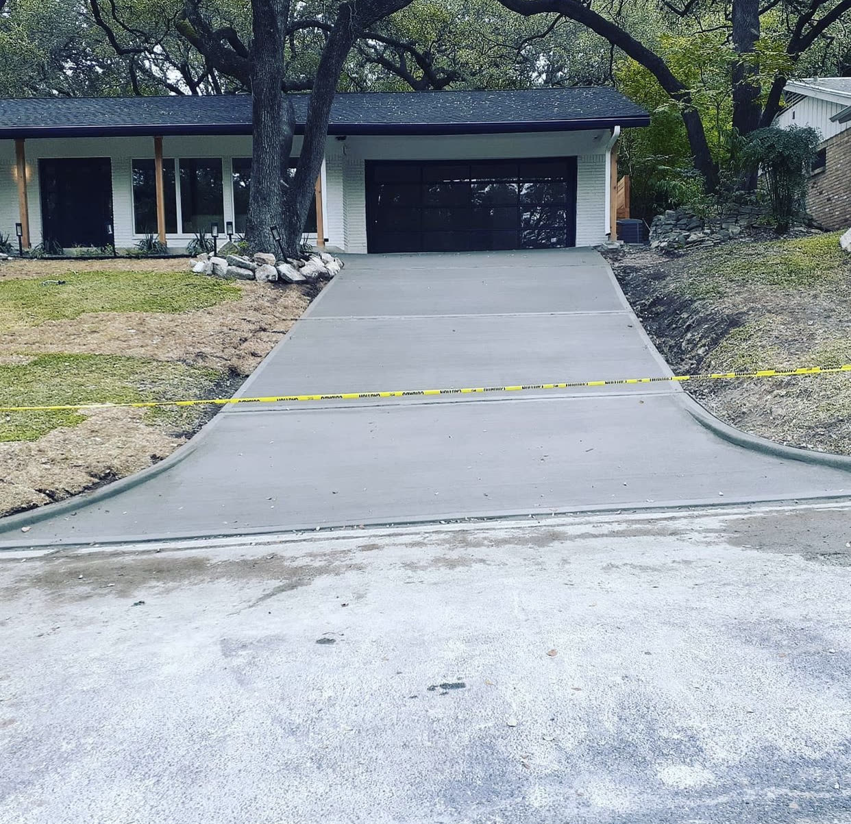 Newly poured concrete driveway leading to a garage