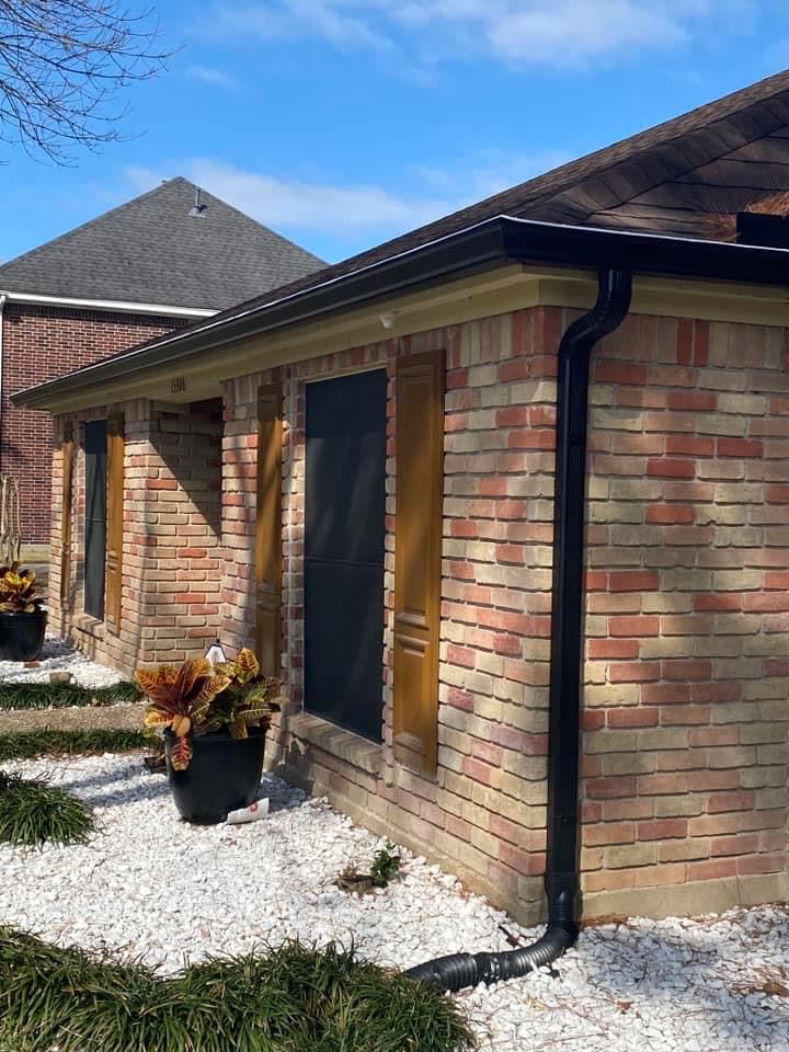 Dark bronze seamless gutter and downspout on a brick home
