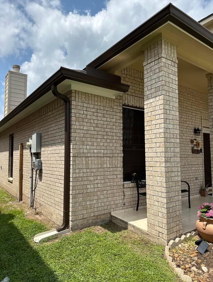 Dark bronze gutters and downspout at a covered patio